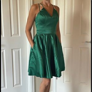 Brand new green satin fit and flare homecoming dress with pockets. Size 3.